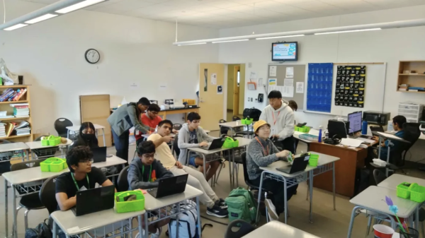 Adhikari aids club members to understand cybersecurity members. (Photo credits: Justin Kuo)